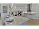 Kitchen with white cabinetry, a large island, and modern appliances at 1074 Signet Dr, Apollo Beach, FL 33572