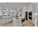 Modern, all-white kitchen featuring an island, stainless steel appliances, and an open-concept design at 1074 Signet Dr, Apollo Beach, FL 33572