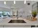 Open-concept kitchen with island sink, breakfast bar, and views of the living area and backyard at 1074 Signet Dr, Apollo Beach, FL 33572
