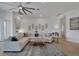 Spacious living room featuring neutral decor, modern ceiling fan, and comfortable seating area at 1074 Signet Dr, Apollo Beach, FL 33572