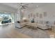 Spacious living room with large sectional sofa, area rug, and sliding glass doors at 1074 Signet Dr, Apollo Beach, FL 33572
