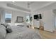 Bright main bedroom boasts tray ceilings, wood floors, and a lovely waterfront view from two windows at 1074 Signet Dr, Apollo Beach, FL 33572