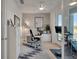 Well-lit home office with a ceiling fan, desk, and access to an outdoor area at 1074 Signet Dr, Apollo Beach, FL 33572
