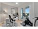 Bright home office with a modern desk, dual monitors, and access to outdoor balcony at 1074 Signet Dr, Apollo Beach, FL 33572