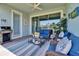 Inviting covered patio with plush seating, barbecue grill, and water views at 1074 Signet Dr, Apollo Beach, FL 33572