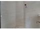 Walk-in shower with tile surround, pebble floor, rainfall shower head, and a built-in niche at 1074 Signet Dr, Apollo Beach, FL 33572