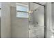 Beautiful shower with a glass door and stone tiling at 1074 Signet Dr, Apollo Beach, FL 33572