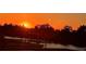 Beautiful sunset featuring a silhouette of trees and a dockside view at 1074 Signet Dr, Apollo Beach, FL 33572