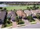 Stunning aerial view of well manicured home, lush yard, and golf course at 13118 Sorrento Way, Bradenton, FL 34211