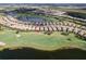 Aerial view of home on golf course with pond in luxurious community at 13118 Sorrento Way, Bradenton, FL 34211