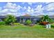 Home with a screened pool and lanai, lush landscaping, and a spacious grassy yard at 13118 Sorrento Way, Bradenton, FL 34211
