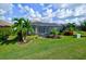 Home with a screened pool and lanai, lush landscaping, and a spacious grassy yard at 13118 Sorrento Way, Bradenton, FL 34211