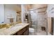 Bathroom with granite countertop, walk-in shower, and neutral tile at 13118 Sorrento Way, Bradenton, FL 34211
