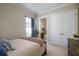 Bedroom with wooden bed frame, en-suite bathroom, and neutral decor at 13118 Sorrento Way, Bradenton, FL 34211