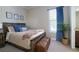 Bedroom with wooden bed frame and neutral color scheme at 13118 Sorrento Way, Bradenton, FL 34211