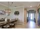 Farmhouse style dining room with a large wooden table and chandelier at 13118 Sorrento Way, Bradenton, FL 34211