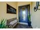 Inviting entryway with a stylish bench and a decorative welcome sign at 13118 Sorrento Way, Bradenton, FL 34211