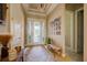 Light and airy entryway with bench and decorative accents at 13118 Sorrento Way, Bradenton, FL 34211