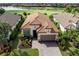 Charming single-Gathering home featuring a Spanish tile roof, manicured lawn, and brick paver driveway at 13118 Sorrento Way, Bradenton, FL 34211