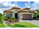 Single story home with tile roof and landscaped yard, paver driveway at 13118 Sorrento Way, Bradenton, FL 34211