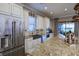 Spacious kitchen features a large island, stainless steel appliances, and opens to backyard at 13118 Sorrento Way, Bradenton, FL 34211