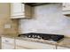 Gas cooktop with granite countertops and custom cabinetry in the kitchen at 13118 Sorrento Way, Bradenton, FL 34211