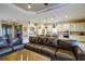 Open concept kitchen with island and stainless steel appliances flows seamlessly into the living room with leather sectional at 13118 Sorrento Way, Bradenton, FL 34211