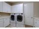 Laundry room with white cabinets and LG washer and dryer at 13118 Sorrento Way, Bradenton, FL 34211