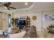 Living room with large TV, sectional sofa, and wooden coffee table at 13118 Sorrento Way, Bradenton, FL 34211
