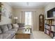 Cozy living room featuring sectional sofa and built-in shelving at 13118 Sorrento Way, Bradenton, FL 34211