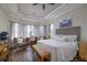 Spacious main bedroom with large bed, sitting area, and hardwood floors at 13118 Sorrento Way, Bradenton, FL 34211