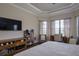 Main bedroom with a king-size bed, TV, and a workspace at 13118 Sorrento Way, Bradenton, FL 34211