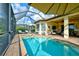 This luxurious pool and spa area offers a covered patio, comfortable seating, and a beautiful view at 13118 Sorrento Way, Bradenton, FL 34211