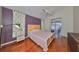 Bright bedroom with wood floors and sliding glass doors to the patio at 16402 Lake Heather Dr, Tampa, FL 33618