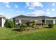 Spacious backyard with a screened-in patio, lush greenery, and well-manicured lawn at 17702 Cresswind Ter, Bradenton, FL 34211