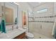 Modern bathroom featuring a walk-in shower, quartz vanity, and decorative mirror at 17702 Cresswind Ter, Bradenton, FL 34211