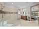 Bright bathroom with a glass-enclosed shower and a view of the outdoor living space at 17702 Cresswind Ter, Bradenton, FL 34211