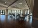 Bright and spacious clubhouse event room with tables, chairs, ample natural light, and a welcoming ambiance at 17702 Cresswind Ter, Bradenton, FL 34211