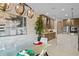 Inviting dining area showcasing modern light fixture, contemporary art and a view of the kitchen at 17702 Cresswind Ter, Bradenton, FL 34211