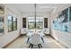 Elegant dining room with modern decor, stylish lighting, and a view to the outdoors at 17702 Cresswind Ter, Bradenton, FL 34211