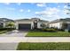 Charming single-story home featuring a well-manicured lawn, landscaped garden, and a paved driveway at 17702 Cresswind Ter, Bradenton, FL 34211