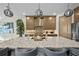 Modern kitchen with a large island, pendant lighting, and stainless steel appliances at 17702 Cresswind Ter, Bradenton, FL 34211