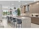Modern kitchen featuring an island with bar stools, stainless steel appliances, and pendant lighting at 17702 Cresswind Ter, Bradenton, FL 34211