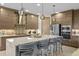 Contemporary kitchen featuring an island with seating, stainless steel appliances, and elegant pendant lights at 17702 Cresswind Ter, Bradenton, FL 34211