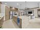 Bright, contemporary kitchen with a center island, stainless steel appliances, and adjacent living area at 17702 Cresswind Ter, Bradenton, FL 34211