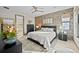 Stylish bedroom with accent wall, natural light and an ensuite bathroom at 17702 Cresswind Ter, Bradenton, FL 34211