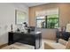 Home office featuring a sleek black desk, comfortable chair, and natural light from the window at 17702 Cresswind Ter, Bradenton, FL 34211