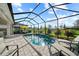 Enjoy the outdoors in this screened pool area with lounge chairs, dining set, and scenic landscaping at 17702 Cresswind Ter, Bradenton, FL 34211
