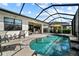 Inviting screened-in pool with comfortable lounge chairs and a dining area, perfect for outdoor entertaining at 17702 Cresswind Ter, Bradenton, FL 34211