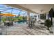 Screened-in pool area features a cozy seating area and dining set for outdoor enjoyment at 17702 Cresswind Ter, Bradenton, FL 34211